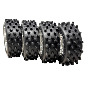 Four black spiked wheels on a white background