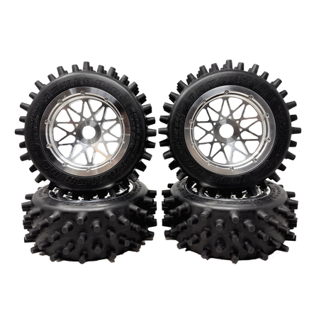 Four black off-road wheels with spiky tire treads on a white background