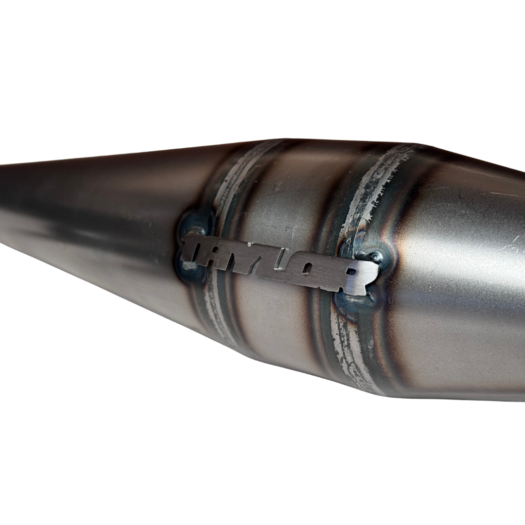 Close-up of Taylor logo tag welded onto 40-50cc Vesla side exhaust pipe