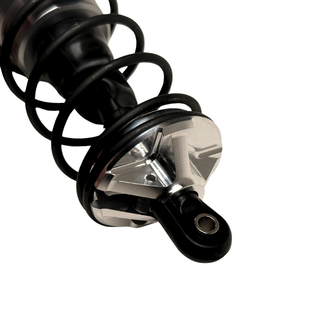 Taylor Losi 5IVE-T 3.0 raw silver billet shock perch fitted to a black shock with spring, side view showing the slot and spoke profile