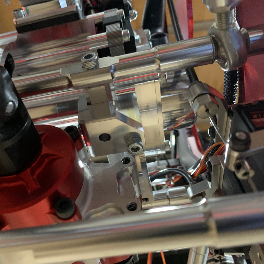 Close-up of a mechanical engine or motor assembly with metallic and red components.