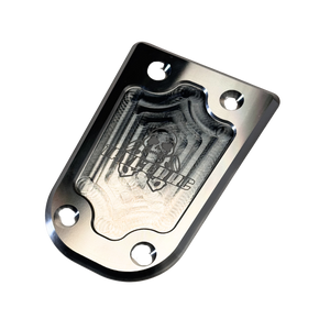Metallic plate with engraved design on a white background