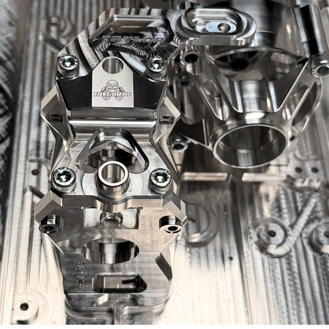 Close-up of metallic engine parts on a textured metal surface