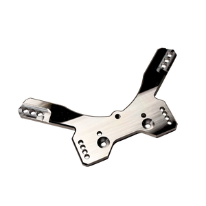 Taylor RC OUTLAW drop rear shock tower in raw silver, angled view from the opposite side showing the shock mounting holes and arm slots
