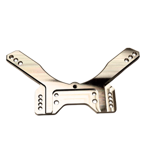 Taylor RC OUTLAW drop rear shock tower in raw silver, flat top-down view showing the full symmetrical arm layout and central cutout