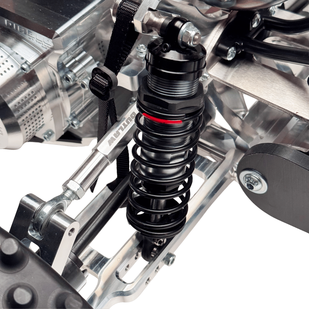 Close-up of a suspension system on a motorcycle with a clear background
