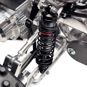Close-up of a suspension system on a motorcycle with a clear background