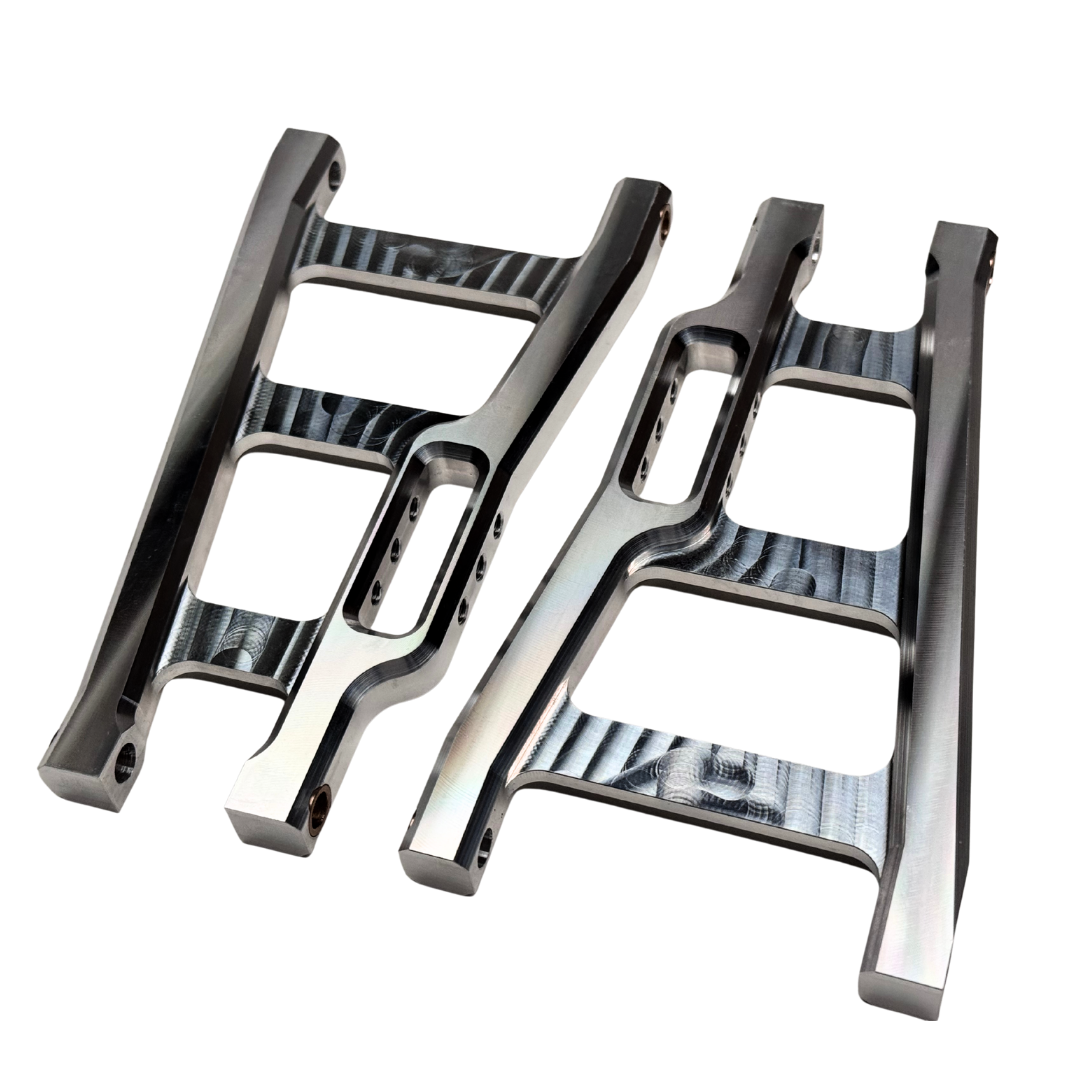 Two metallic suspension links on a white background