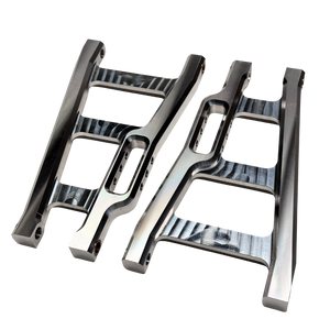 Two metallic suspension links on a white background