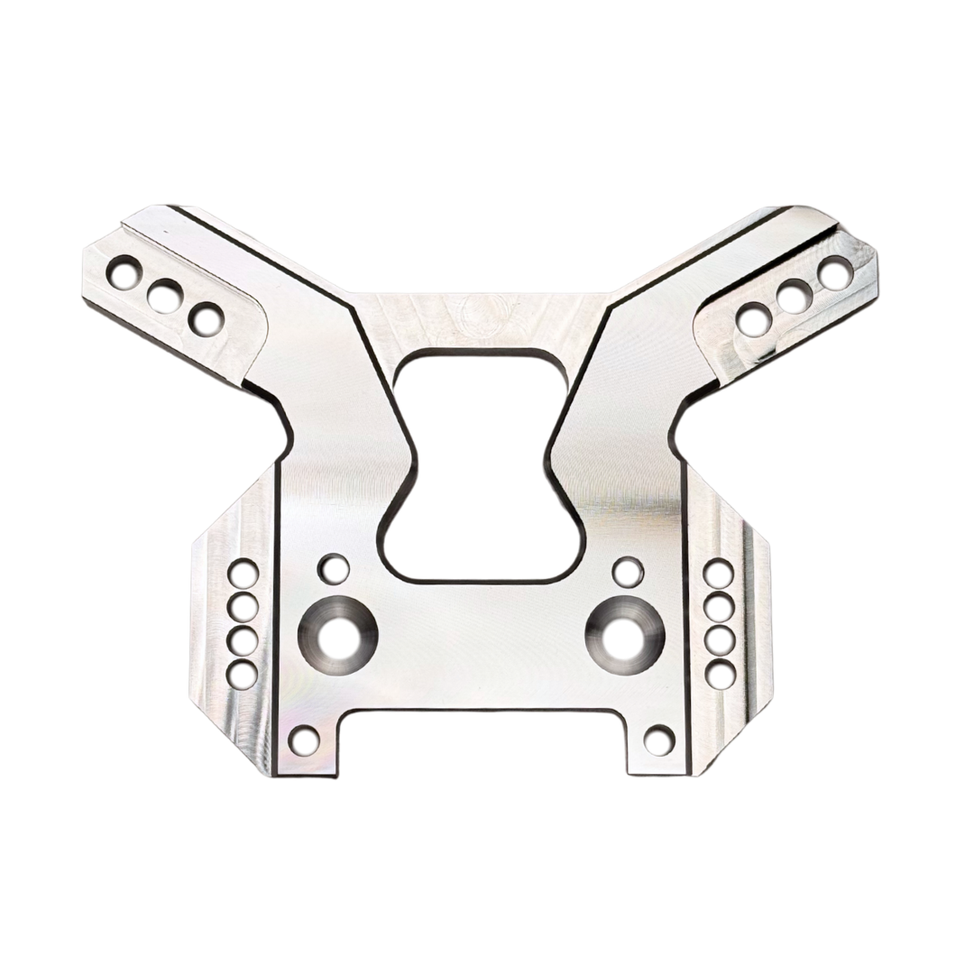 Taylor RC OUTLAW V4 front shock tower in raw silver, flat top-down view showing the full symmetrical arm layout and central cutout