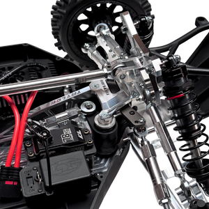 Close-up of a detailed model vehicle chassis with suspension and electronic components.