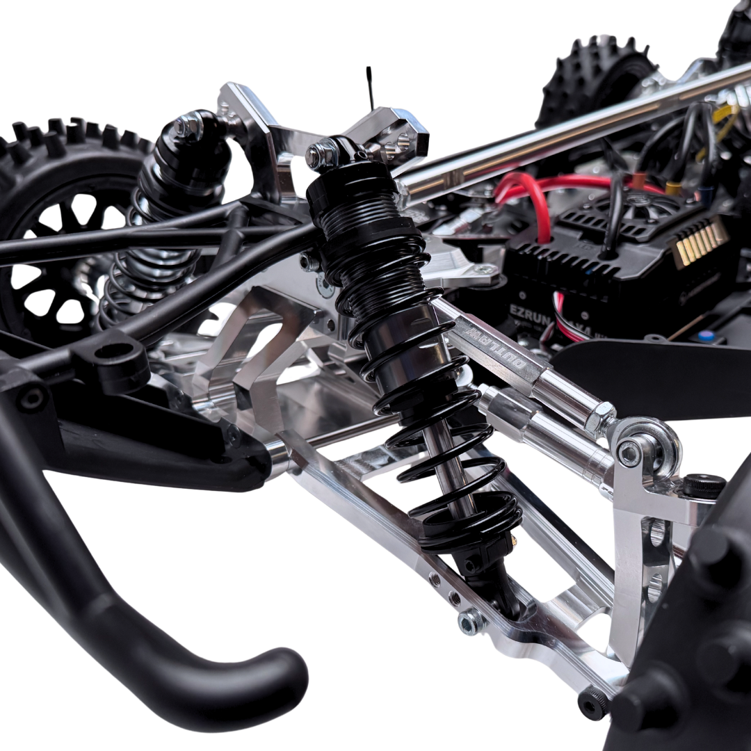 Close-up of a detailed model vehicle chassis with suspension and steering components.