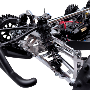 Close-up of a detailed model vehicle chassis with suspension and steering components.
