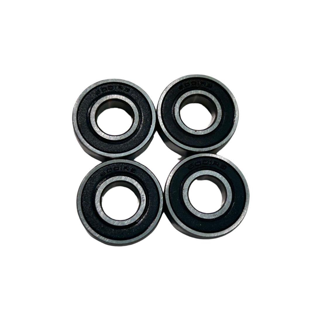 Four black and silver bearings on a white background