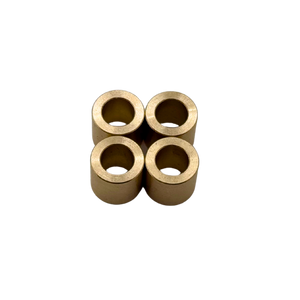 Four brass bushings on a white background