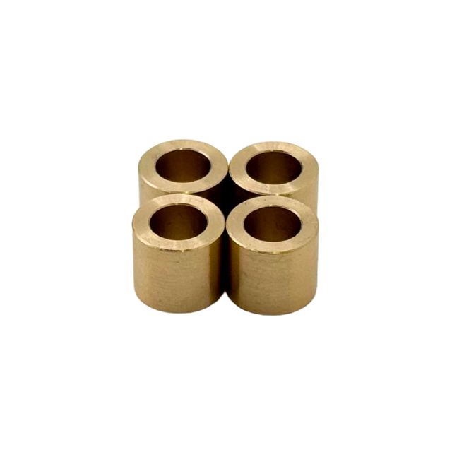 Four cylindrical brass bearings arranged in a cross formation on a white background.