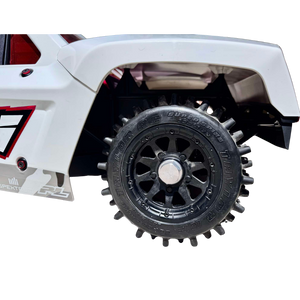 Close-up of a toy truck with a detailed wheel and white body on a white background