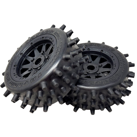 Two black off-road wheels with spiky tread pattern on a white background