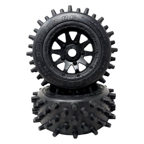 Black RC tire with spiky tread pattern on a white background