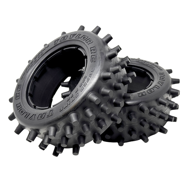 Two black off-road tires with spiky tread pattern on a white background