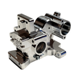 Taylor RC V2 billet 3-piece Vesla transmission housing in raw silver, viewed from a front 45-degree angle