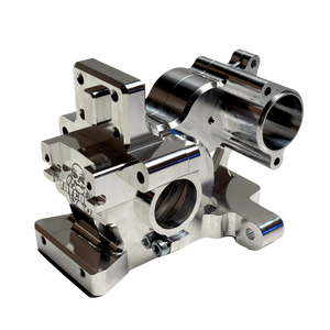 Taylor RC V2 billet 3-piece Vesla transmission housing in raw silver, viewed from a front 45-degree angle