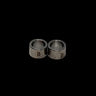 Pair of silver bushings with engraved tzz logo on a black background